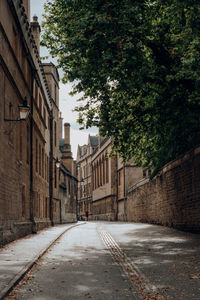 View of a quiet street in old town of oxford, uk, person walks in the distance.