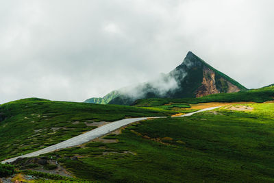 Scenic view of landscape against cloudy sky