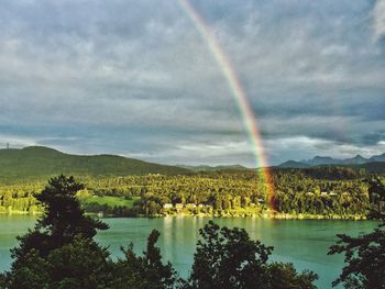 Scenic view of rainbow over mountain against sky