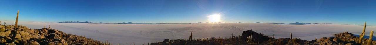 Panoramic view of landscape against clear blue sky