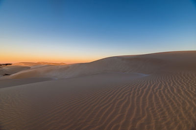 Scenic view of desert against clear sky