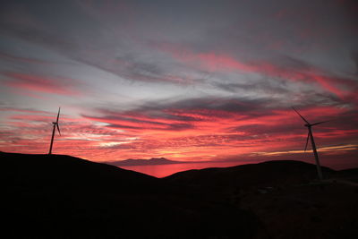 Scenic view of silhouette mountains against orange sky