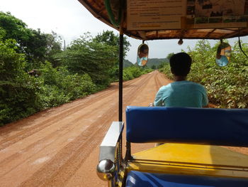 Rear view of man sitting in bus