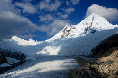 Scenic view of mountains against cloudy sky