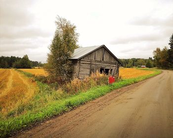 Dirt road passing through field