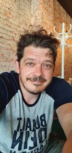 Portrait of man against wall