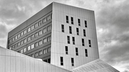 Low angle view of building against cloudy sky