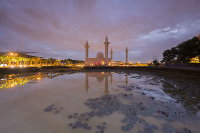 View of illuminated cathedral against cloudy sky