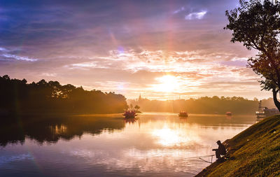 Scenic view of lake against sky during sunset