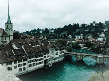 Bridge over river with buildings in background