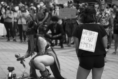 Women performing on street in city