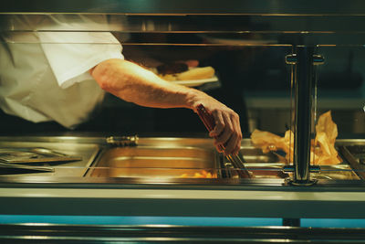 Midsection of man preparing a dish 