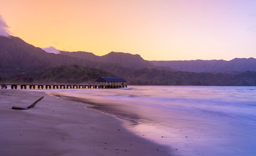 Scenic view of beach against sky during sunset