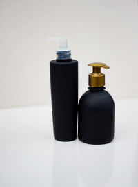 Close-up of bottle on table against white background