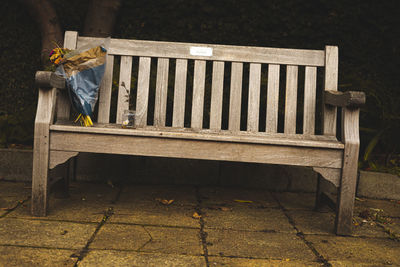 Low section of man sitting on bench in park