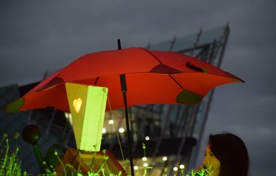 Illuminated city against sky at night