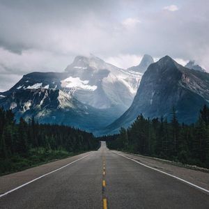 Road amidst mountains against sky