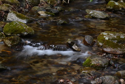 Stream flowing through rocks in river