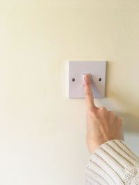 Close-up of human hand against the wall