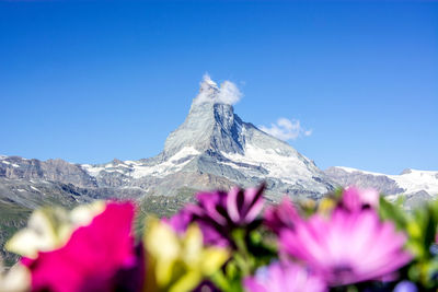 Scenic view of snow covered mountain against clear sky