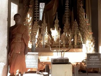 Woman standing in illuminated temple