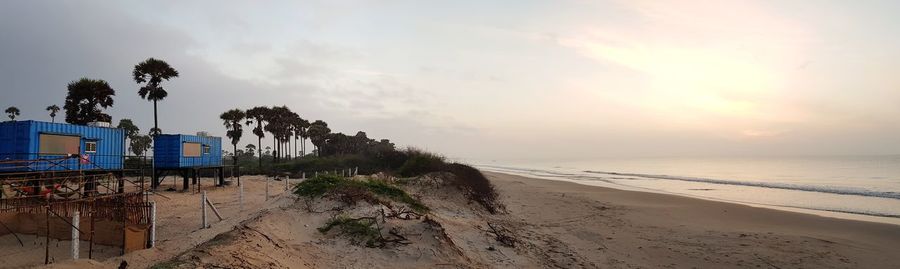 Scenic view of beach against sky during sunset