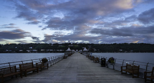 Pier over sea against sky at dusk