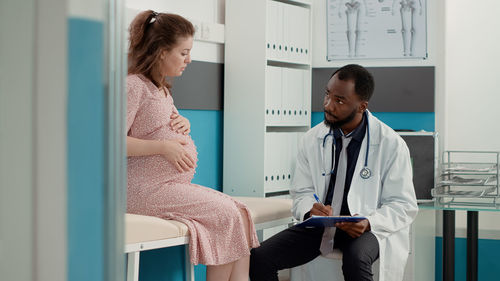 Doctor examining pregnant woman at medical clinic