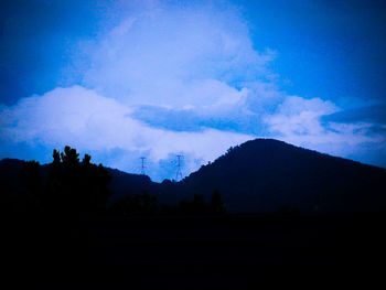 Scenic view of silhouette mountains against sky at night