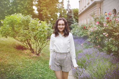 Optimistic asian young woman in a park, outdoor summer portrait