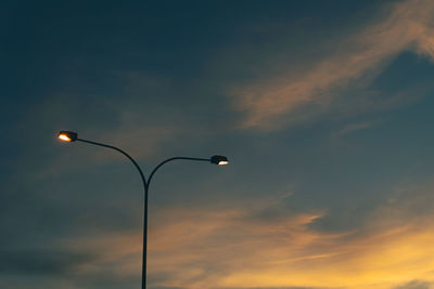 Low angle view of street light against sky during sunset