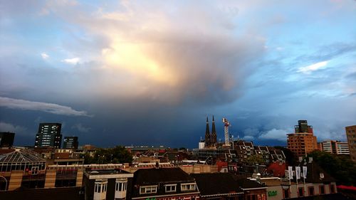High section of cityscape against cloudy sky