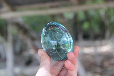 Cropped image of person holding crystal ball
