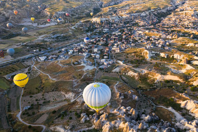 High angle view of hot air balloon flying over land