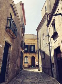 Narrow alley amidst old buildings in city