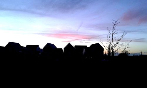 Silhouette buildings against sky