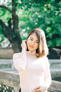 Portrait of smiling young woman standing outdoors