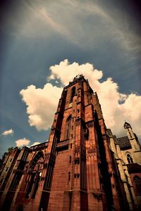 Low angle view of temple against cloudy sky