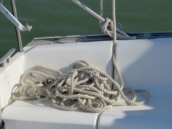 Close-up of rope tied to fishing net at harbor