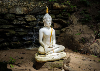 Statue of buddha against temple