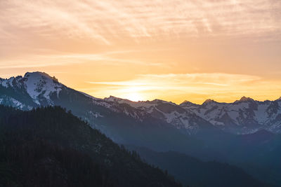 Scenic view of snowcapped mountains against sky during sunset