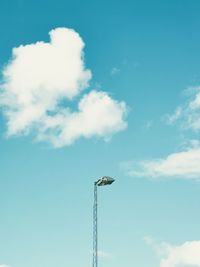 Low angle view of crane against sky