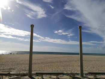 View of beach against cloudy sky