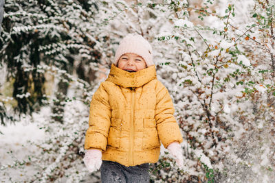 Portrait of a boy standing in snow