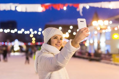 Portrait of young woman using mobile phone