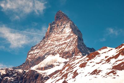 Aerial view of snowcapped mountains against sky