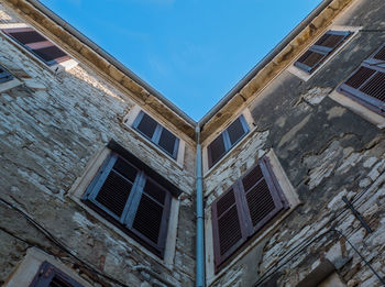 Low angle view of old building against clear blue sky