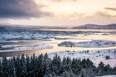 Scenic view of frozen lake against sky during winter