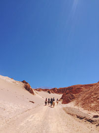 People walking on dirt road