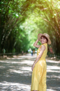 Portrait of young woman standing in forest